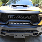RAM TRX Lightbar 23in PRO installed in factory grille opening on yellow 2021-2024 RAM 1500 TRX front view