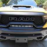 RAM TRX Lightbar 23in PRO installed in factory grille opening on yellow 2021-2024 RAM 1500 TRX front view