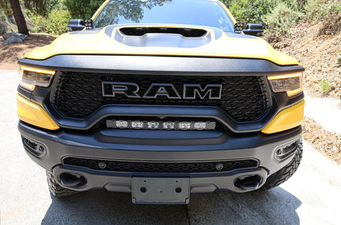 RAM TRX Lightbar 23in PRO installed in factory grille opening on yellow 2021-2024 RAM 1500 TRX front view
