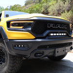 RAM TRX Lightbar 23in PRO installed in grille opening on yellow 2021-2024 RAM 1500 TRX front bumper view