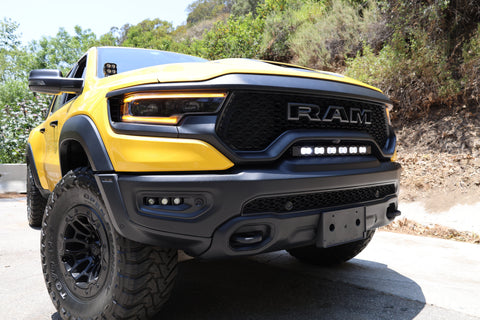 RAM TRX Lightbar 23in PRO installed in grille opening on yellow 2021-2024 RAM 1500 TRX front bumper view