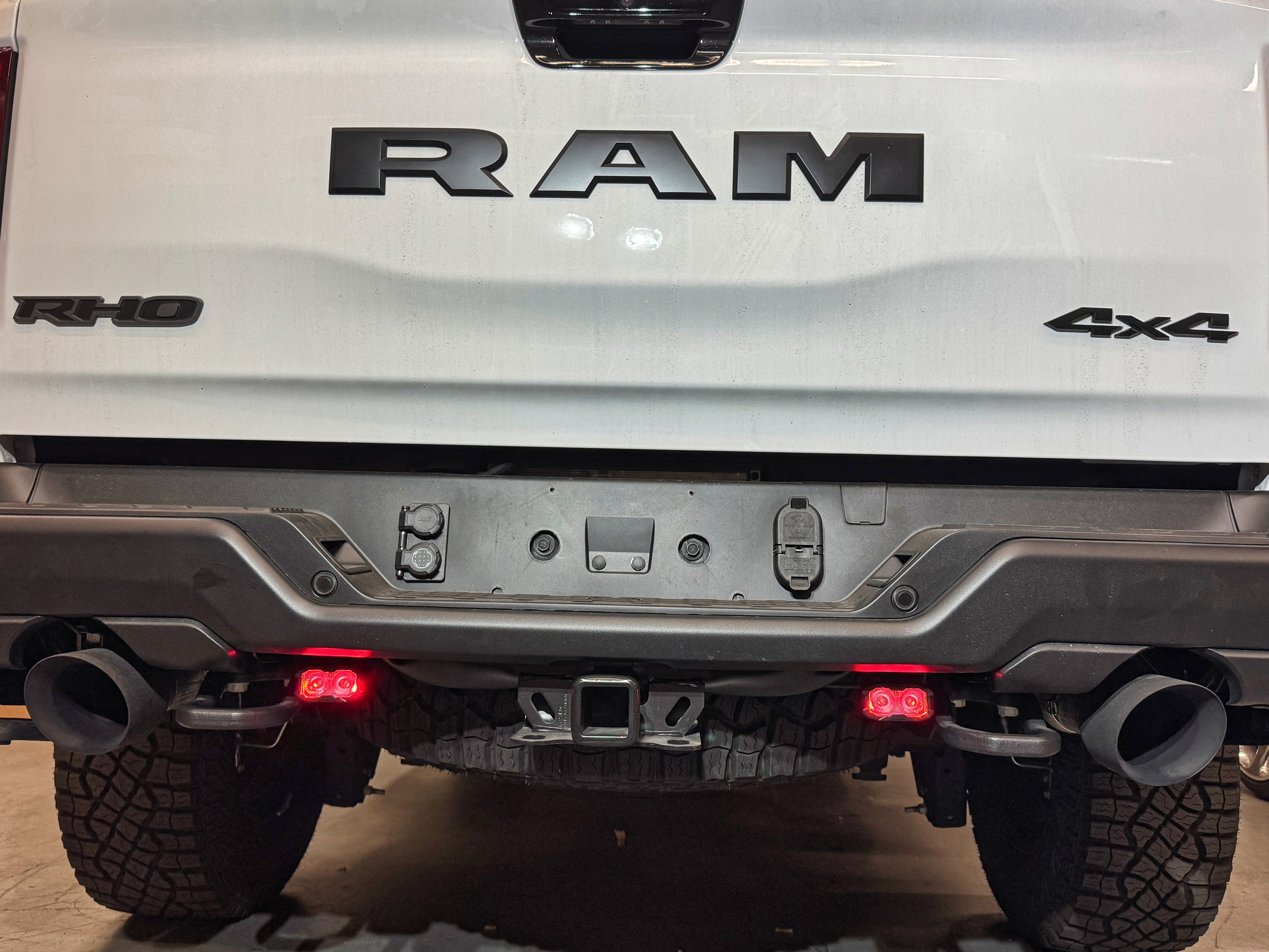 RAM RHO REVERSE Reverse Light Kit on 2025-2026 RAM 1500 RHO — pair of white LED pods with amber/red backlight options for turn signal or brake