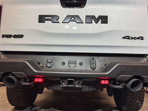 RAM RHO REVERSE Reverse Light Kit on 2025-2026 RAM 1500 RHO — pair of white LED pods with amber/red backlight options for turn signal or brake