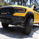 RAM TRX Lightbar 23in PRO installed on yellow RAM 1500 TRX 2021-2024 between grille and bumper on mountain road