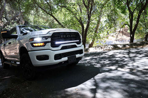 2025+ RAM 2500 light bar slim 40in installed on white RAM 2500 truck parked on shaded forest road
