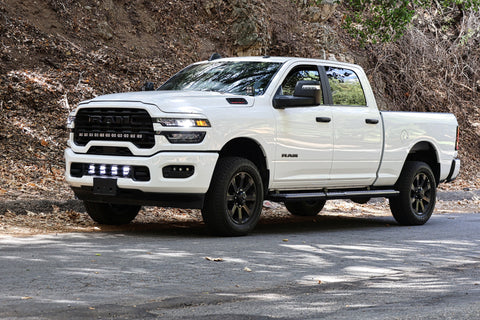 2025+ RAM 2500 Light kit with lower grille LED pods installed on white RAM 2500 truck parked on roadside