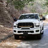 2025+ RAM 2500 Light kit lower grille pods installed on white RAM 2500 truck driving on wooded road