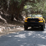 Yellow RAM TRX Light bar installed in grille opening, 23in slim curved LED light bar on 2021-2024 RAM 1500 TRX driving in sunlight