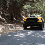 Yellow RAM TRX Light bar installed in grille opening, 23in slim curved LED light bar on 2021-2024 RAM 1500 TRX driving in sunlight