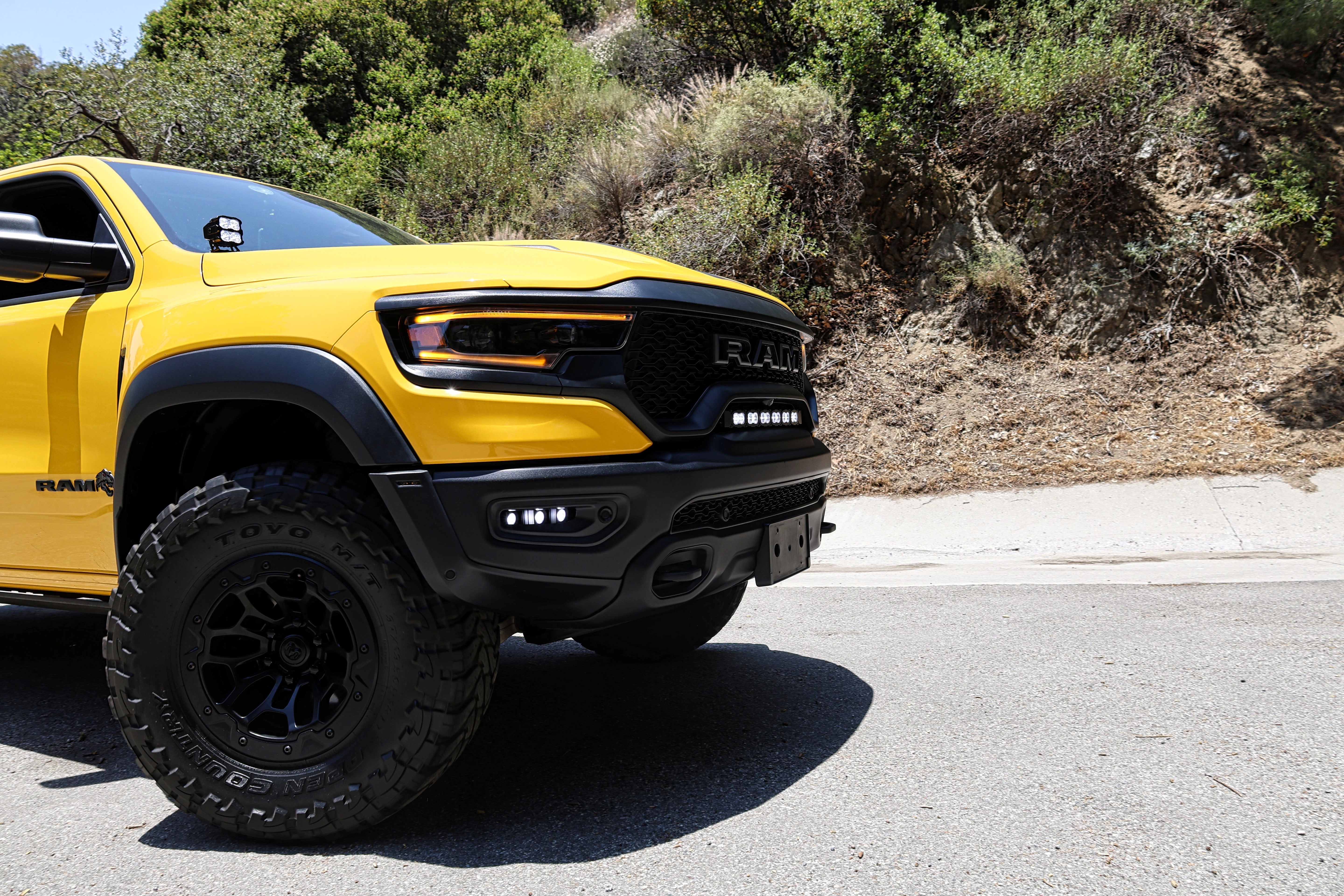 RAM TRX Lightbar 23in PRO installed on yellow 2021-2024 RAM 1500 TRX front grille and bumper opening