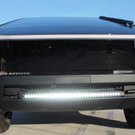 front view black tesla cybertruck with white curved LED light bar in the bumper
