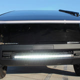 front view black tesla cybertruck with white curved LED light bar in the bumper
