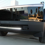 black tesla cybertruck with white curved LED light bar in the bumper