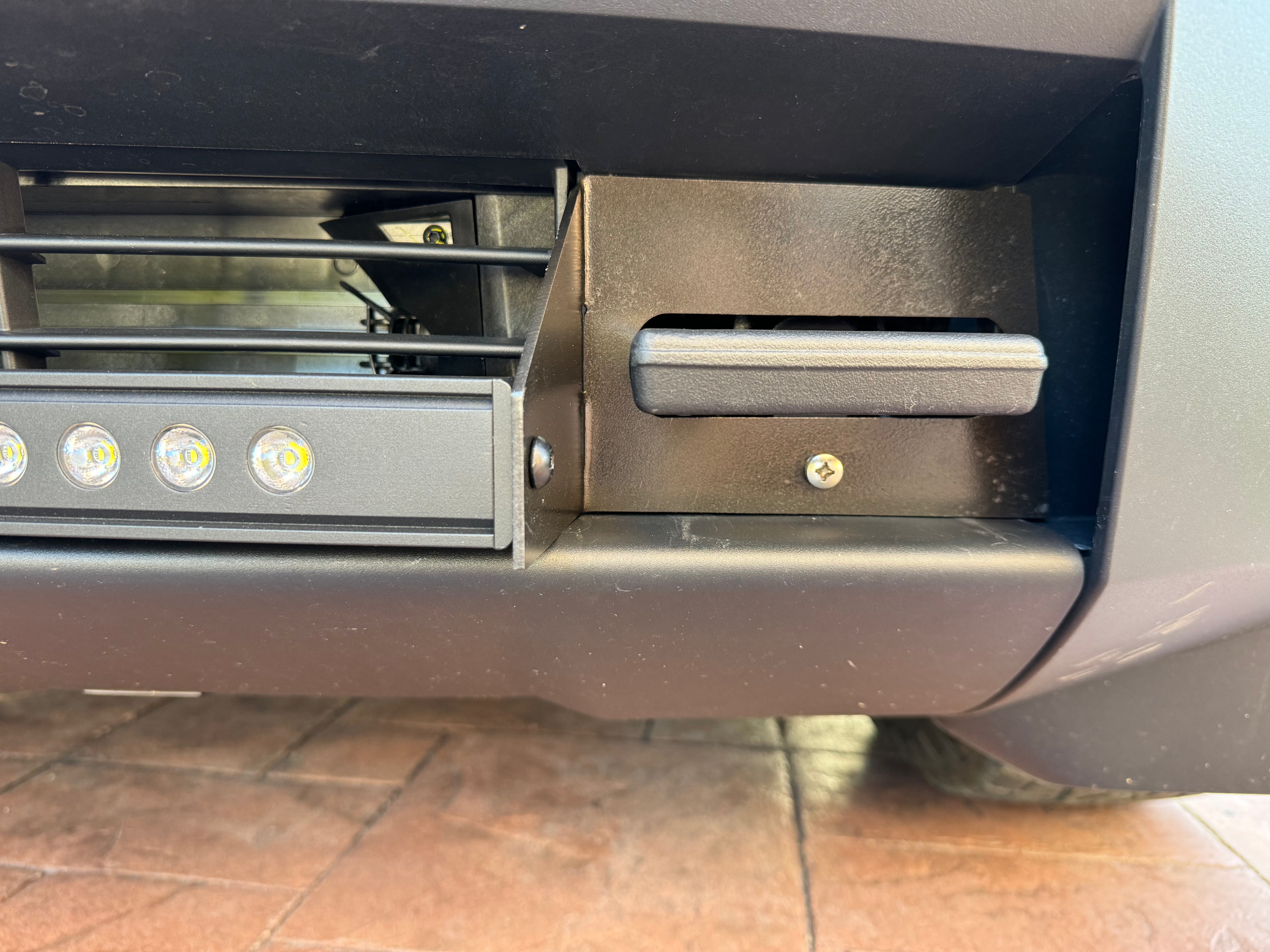 upclose view of tesla cybertruck light bar and metal bracket