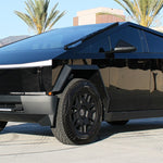 black tesla cybertruck with white curved LED light bar in the bumper
