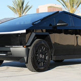 black tesla cybertruck with white curved LED light bar in the bumper