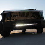 black tesla cybertruck with white curved LED light bar in the bumper
