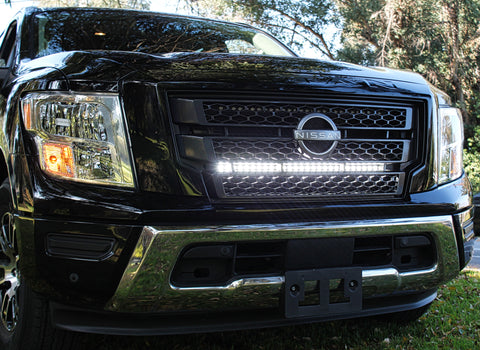 black nissan titan with one led light bar behind the grille in white color for off roading