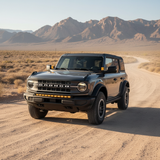 Bronco Raptor ditch lights PRO on a rugged desert trail, dual-color white LED with amber DRL backglow