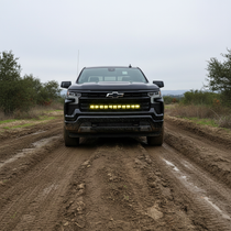 chevrolet Silverado 1500 Light Bars PRO mounted on 2022 Silverado 1500 bottom grille driving on muddy off-road trail