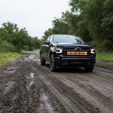 Chevrolet Silverado 1500 PRO light bars on a 2022+ Silverado lighting a muddy off-road trail at dusk