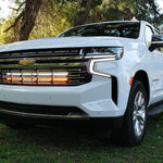 white 2021 2022 2023 2024 Chevrolet Suburban with 2 led lights bars behind the grille amber and white for off roading