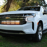 white 2021 2022 2023 2024 Chevrolet Suburban with 2 led lights bars behind the grille amber and white for off roading