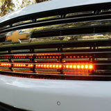 white 2021 2022 2023 2024 Chevrolet Suburban with one led amber light bars behind the grille for off roading