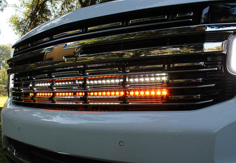 front view of grille 2021 Chevrolet Suburban with 2 led lights bars behind the grille amber and white for off roading