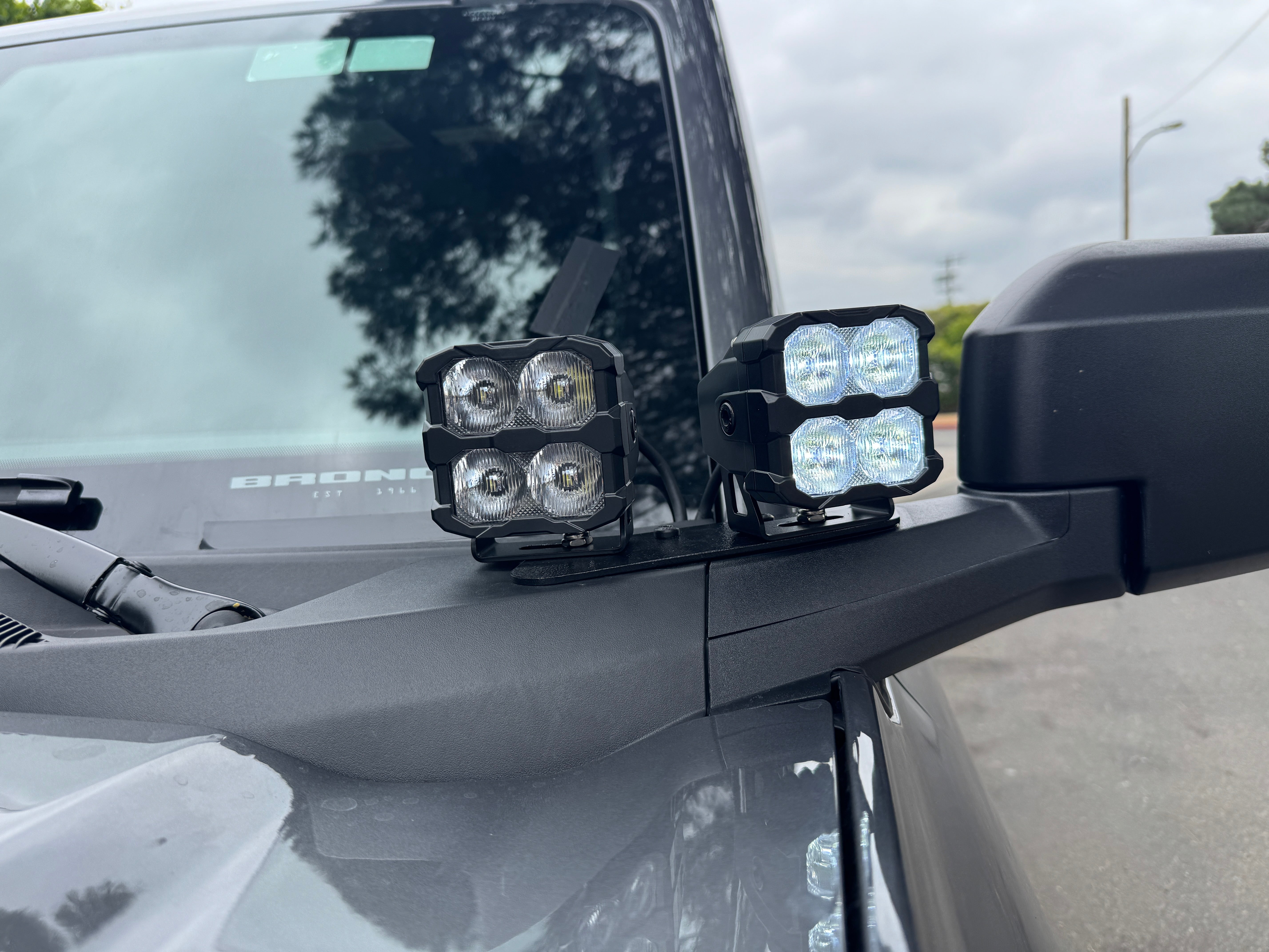 Ford Bronco ditch lights PRO, dual-color white LED with amber DRL backglow on a 2021-2026 Bronco