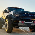 front view ford bronco raptor with amber drl led light bar on bumper and roof plus fog lights