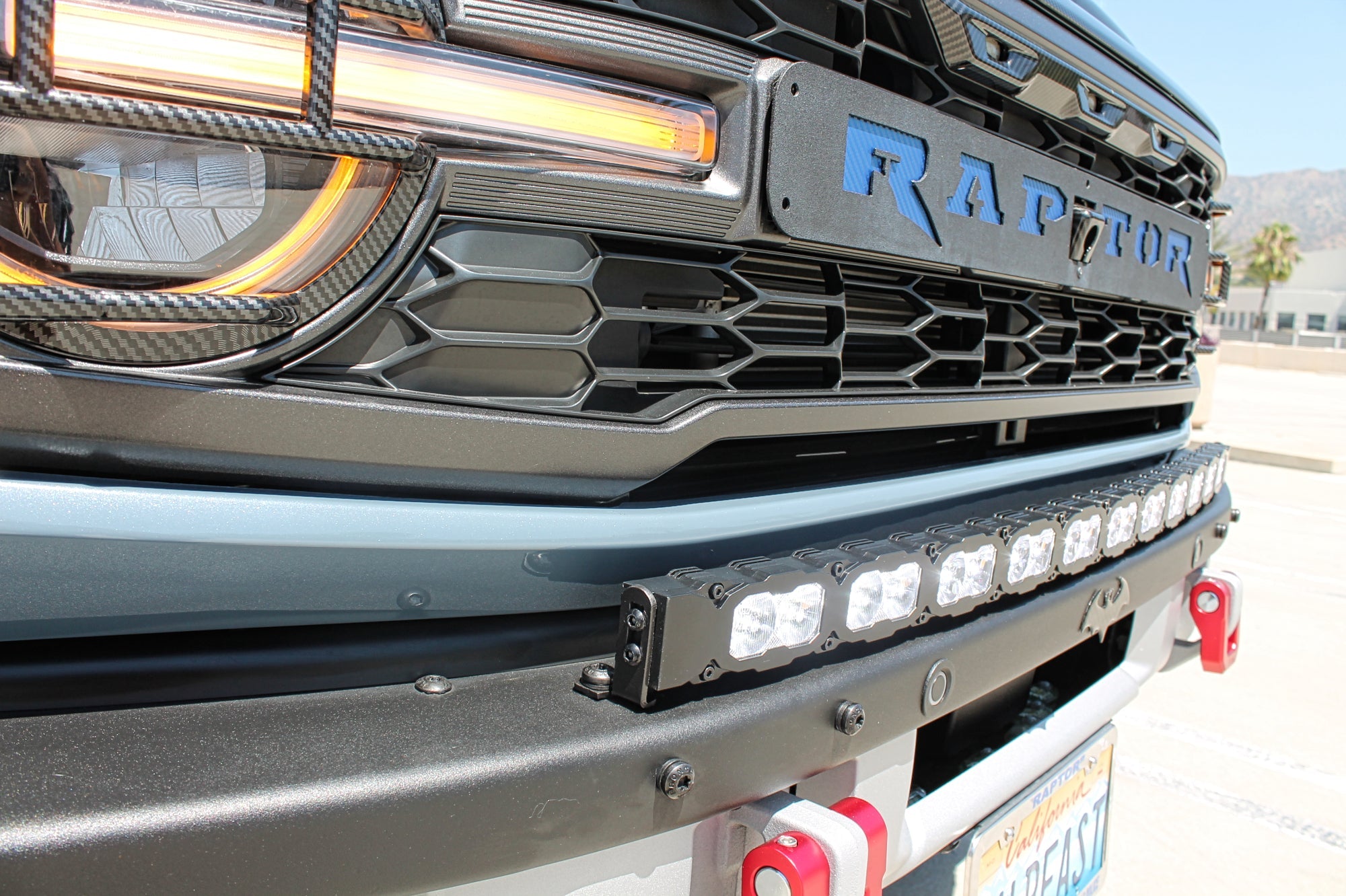 side view ford bronco raptor with white curved led light bar on top of bumpe