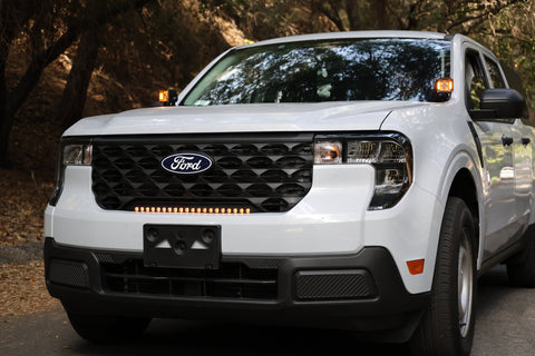 Ford Maverick Ditch Lights 2025+ dual color amber DRL installed on white Ford Maverick front view in wooded setting