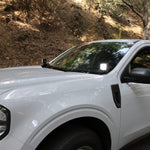 Ford Maverick Ditch Lights installed on white 2025 Ford Maverick truck parked on forest road
