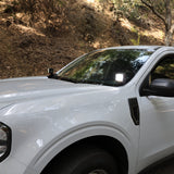 Ford Maverick Ditch Lights installed on white 2025 Ford Maverick truck parked on forest road