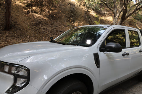 Ford Maverick Ditch Lights installed on white 2025 Ford Maverick truck parked on forest road