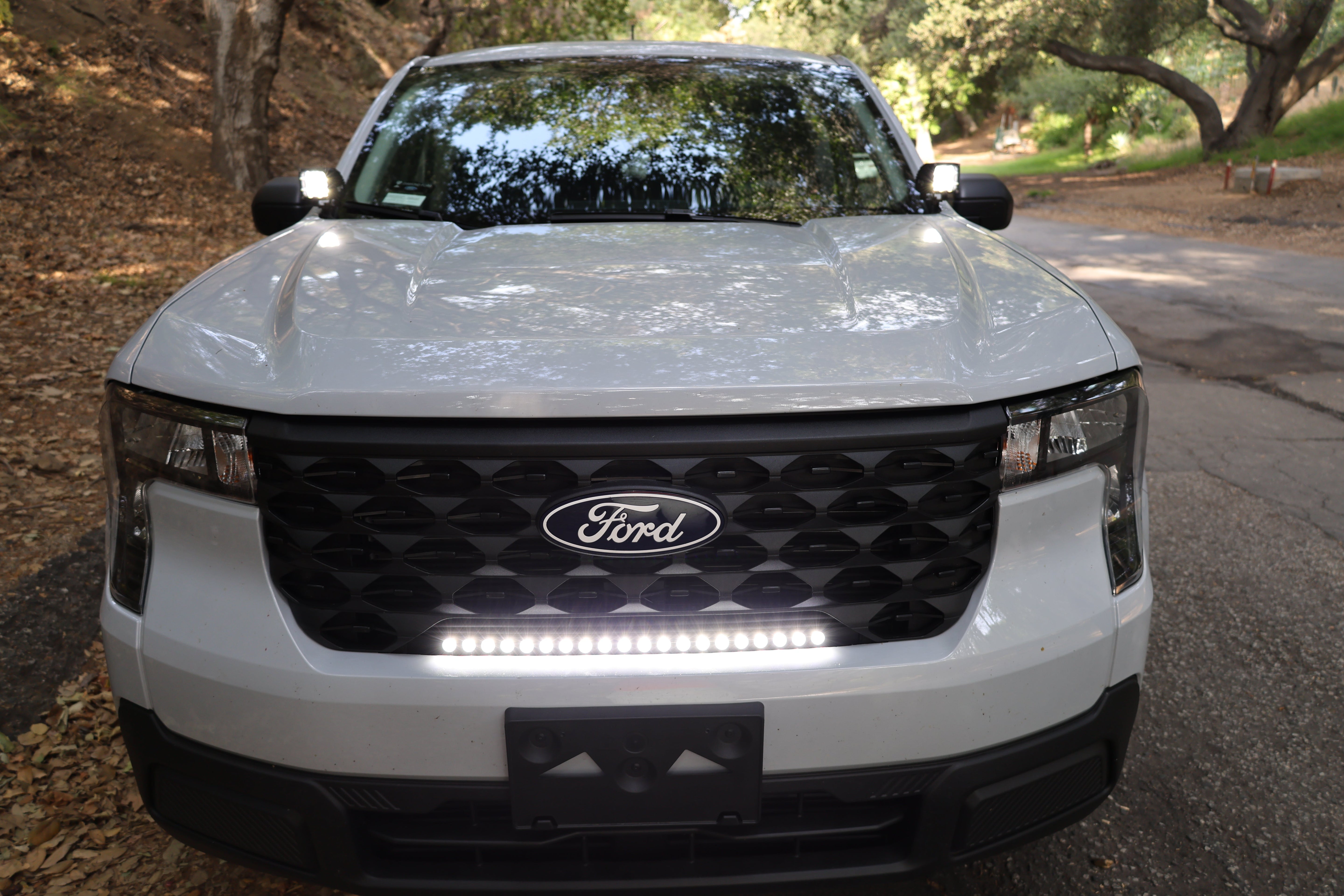 Ford Maverick Ditch Lights 2025 front view with dual color white LED bar and amber DRL installed on white Maverick truck