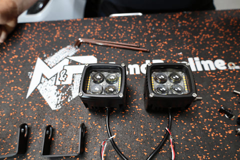 Dual color Ford Maverick Ditch Lights 2025+ LED pods with amber DRL backglow on install bench