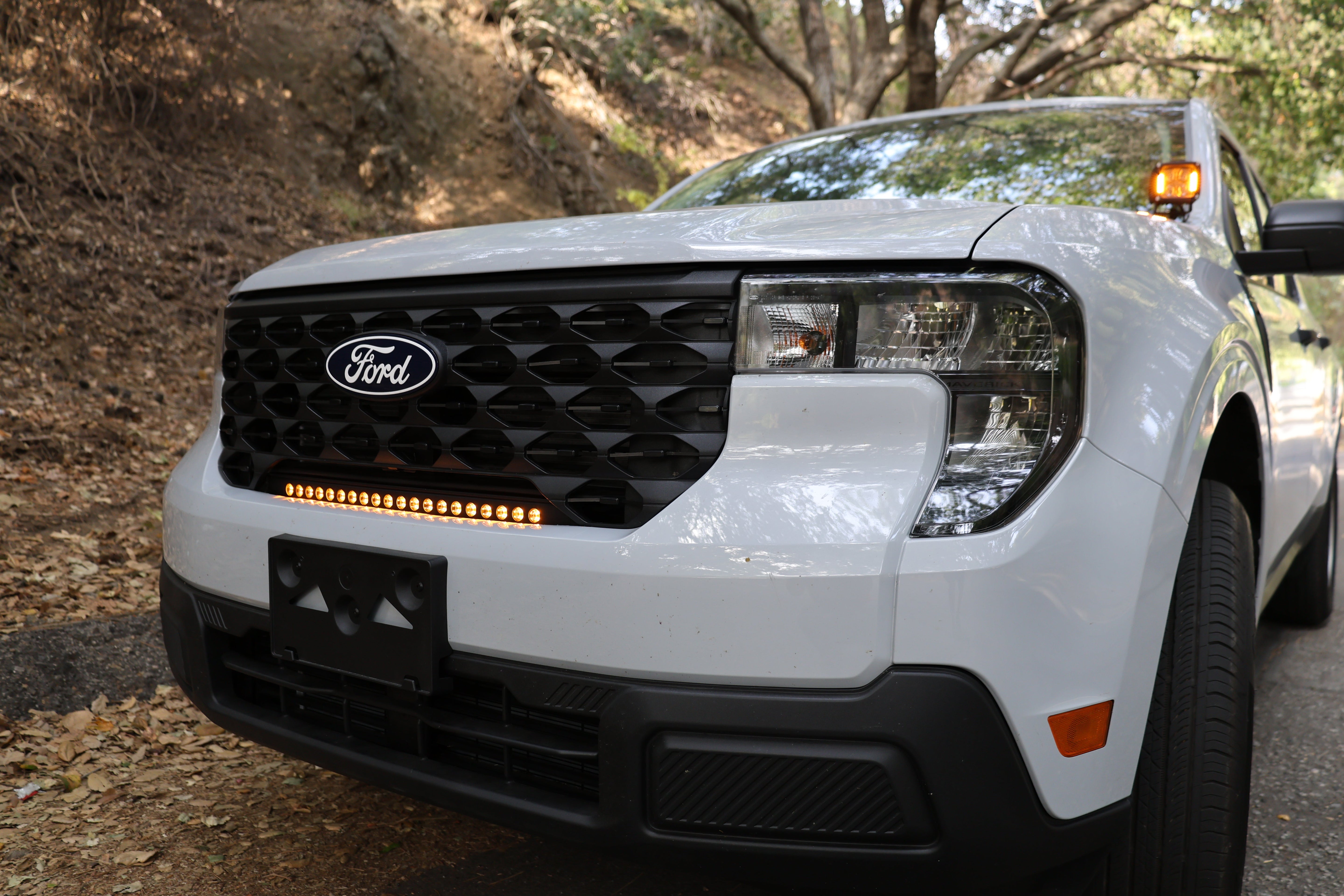 Ford Maverick Ditch Lights on 2025+ white Ford Maverick with amber DRL backglow installed on front for XL XLT Lariat trims