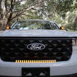 ford maverick light bar 23in installed on 2025 Ford Maverick grille, slim curved amber LED light bar glowing on front bumper