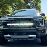 Front view of a black 2024 Ford Ranger Raptor showcasing hood mount LED lights on a sunny day.