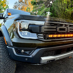 2024 Ford Ranger Raptor with hood mount LED lights showcasing amber DRL backglow in outdoor setting.
