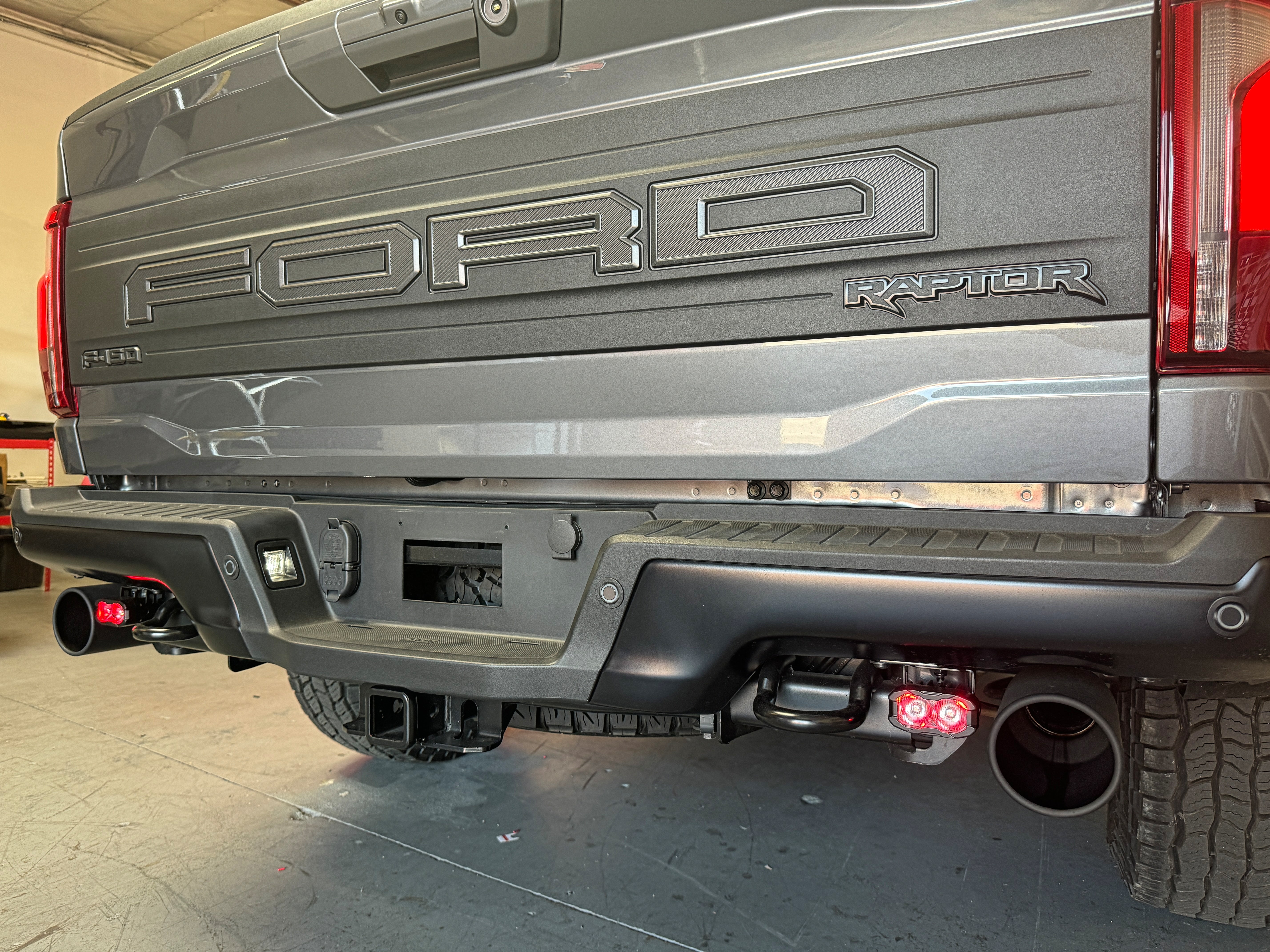 Ford Raptor Gen 3 reverse kit product image for 2024+ refresh - rear bumper with tow hitch and exhaust, showcasing Gen 3 Raptor details