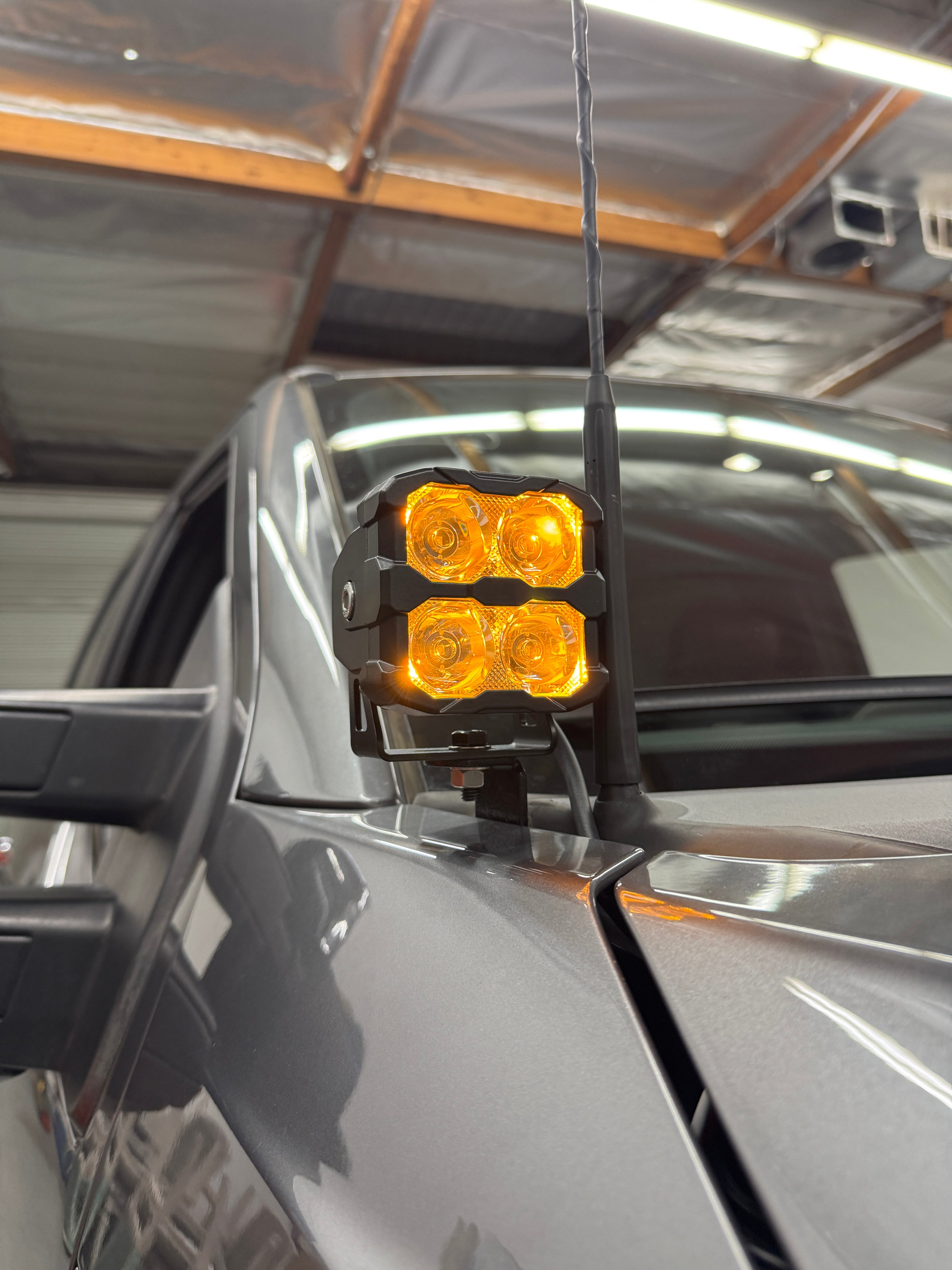 Ford Super Duty Ditch Lights PRO 2023+ F250/350/450 mounted on mirror with amber LED pods illuminated
