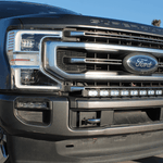 Ford Super Duty light bar on 2020-2022 F250/F350/F450 front grille - Ford badge, chrome bumper, low angle shot