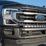 Ford Super Duty light bar on 2020-2022 F250/F350/F450 front grille - Ford badge, chrome bumper, low angle shot