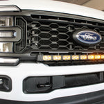 white 2023 2024 ford superduty with 40in curved LED light bar on top of bumper , amber day time running lights are on