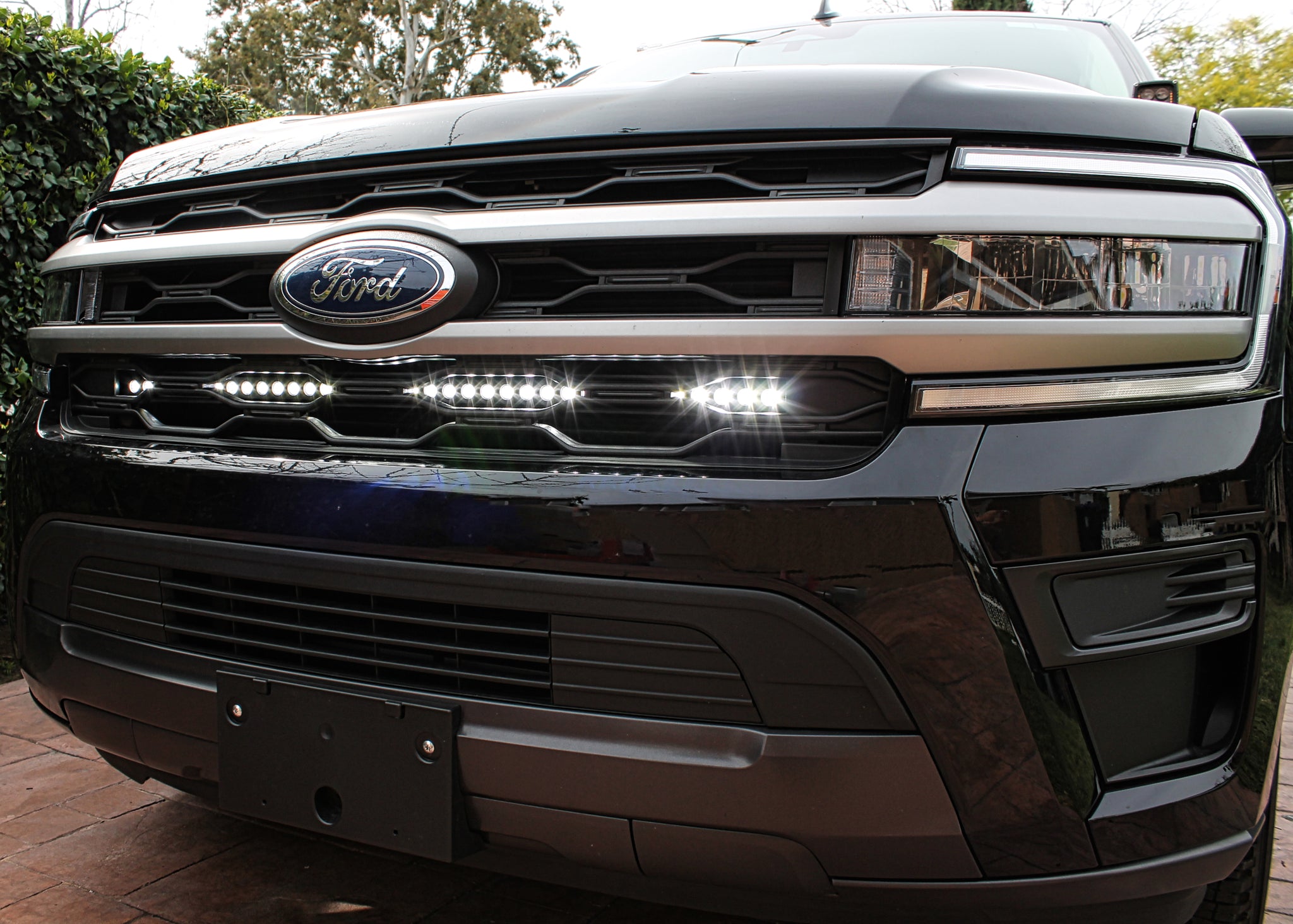 black ford expedition with behind grille led light bar color white for off roading