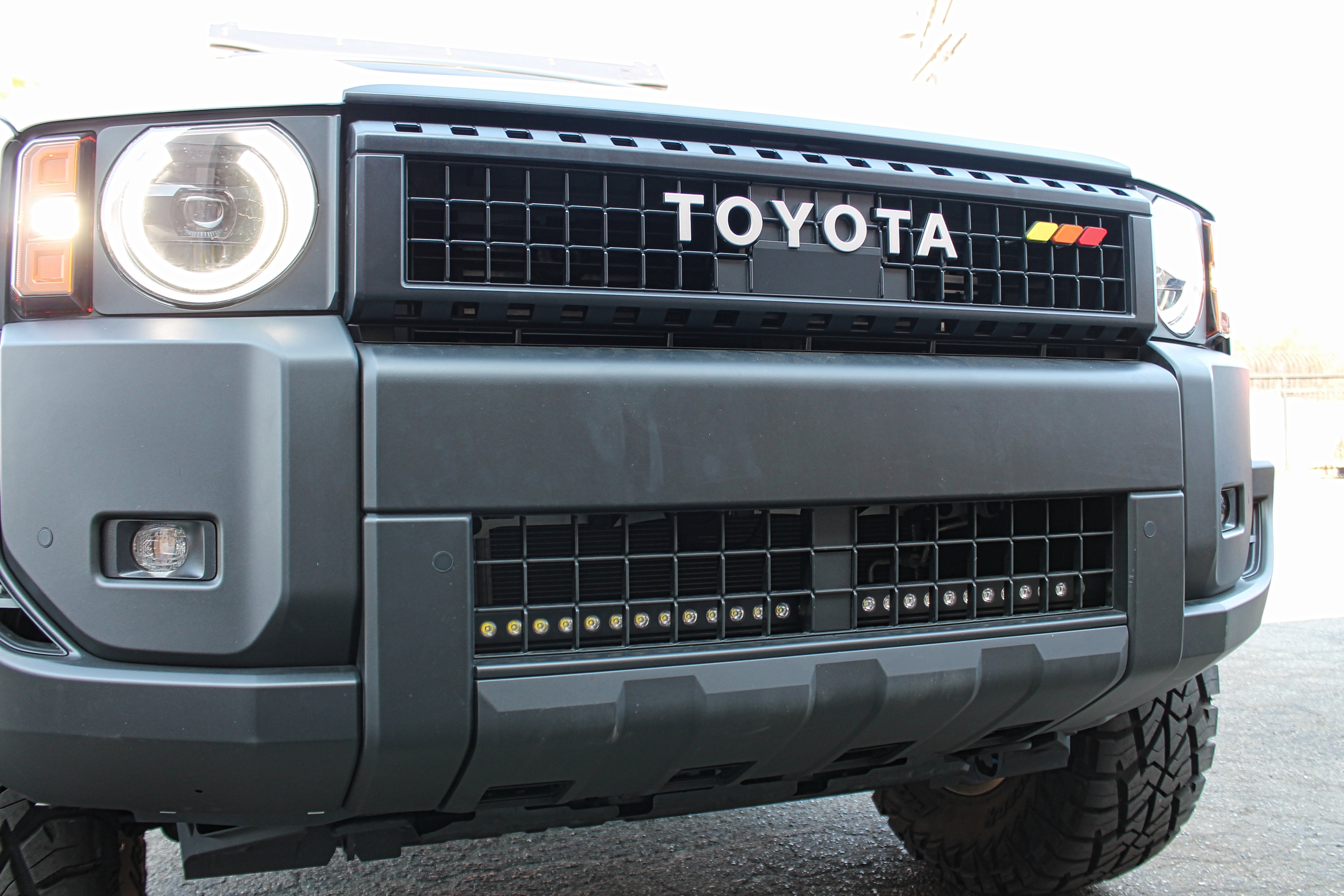 Land Cruiser lightbar on 2024+ Toyota Land Cruiser with front grille removed for install, showcasing install behind lower grille and radiator airflow unaffected