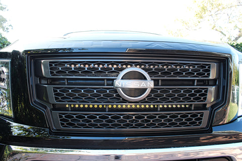 black nissan titan front view with off road led light bars behind the grille
